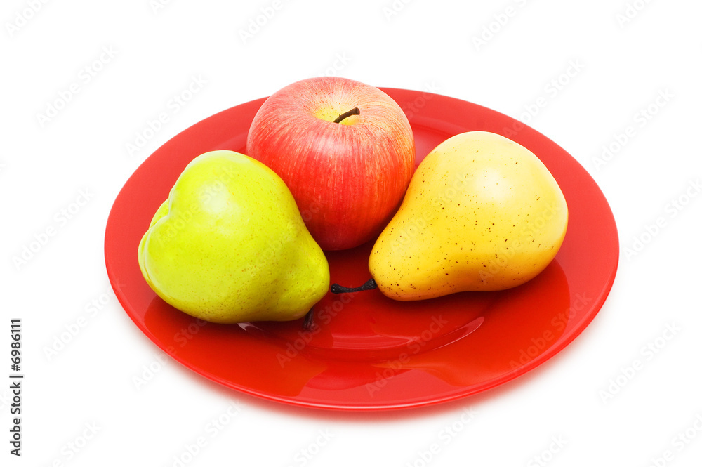 Various fruits and red plate isolated on white