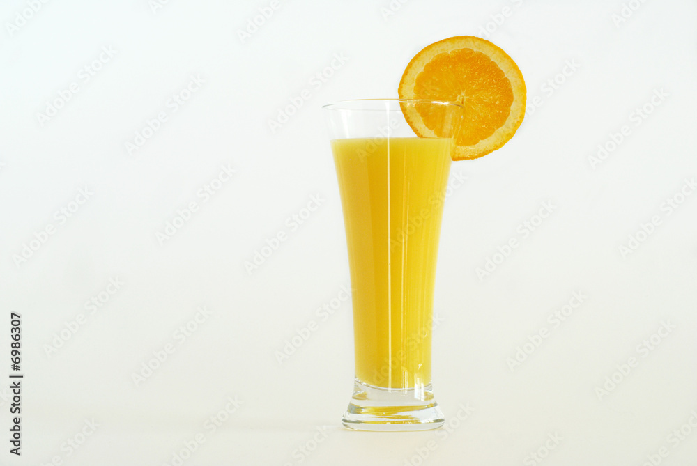 An Easter drink of orange juice decorated with a slice of an orange on white background. Copy space.