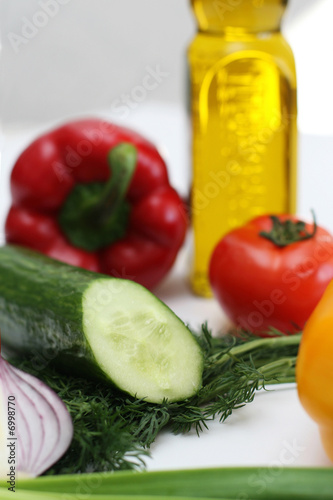 Multi-coloured vegetables for salad on a white background