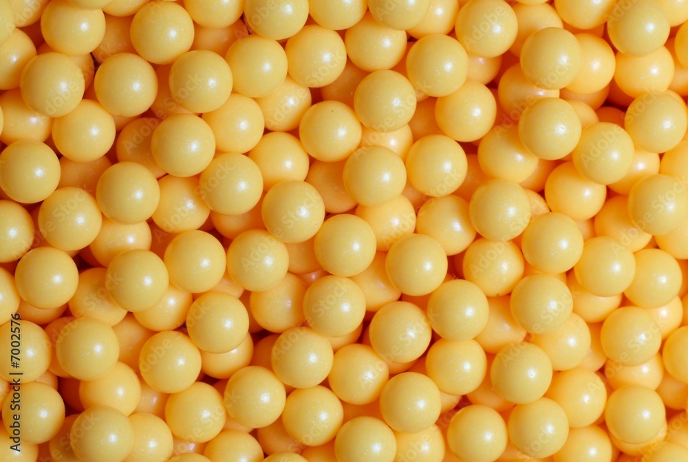 A pile of yellow round balls. A pile of yellow round balls.