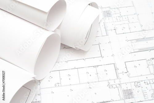 rolled blueprints and yellow marker
