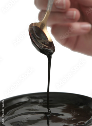 Drops of chocolate on the spoon and a plate