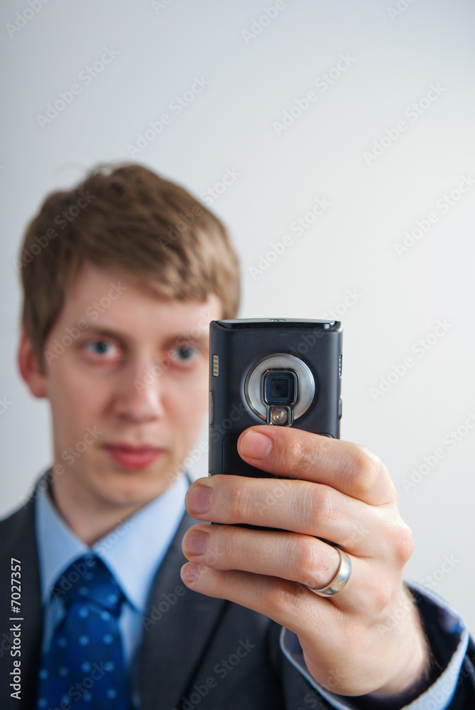 businessman taking a picture with his mobilephone businessman taking a picture with his mobilephone