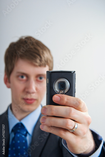 businessman taking a picture with his mobilephone