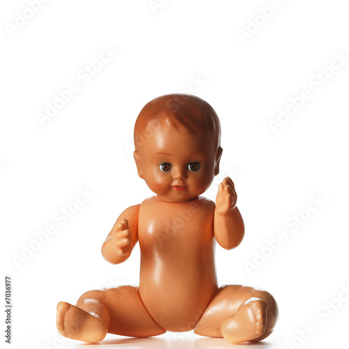 A portrait of a plastic sitting child isolated on white