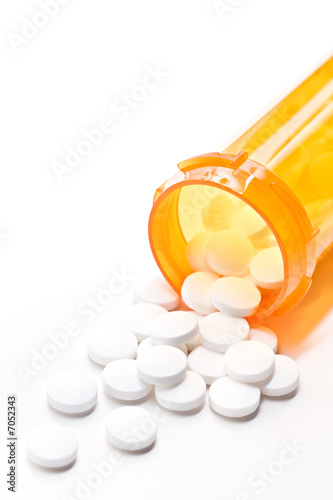 pills with bottle on white photo