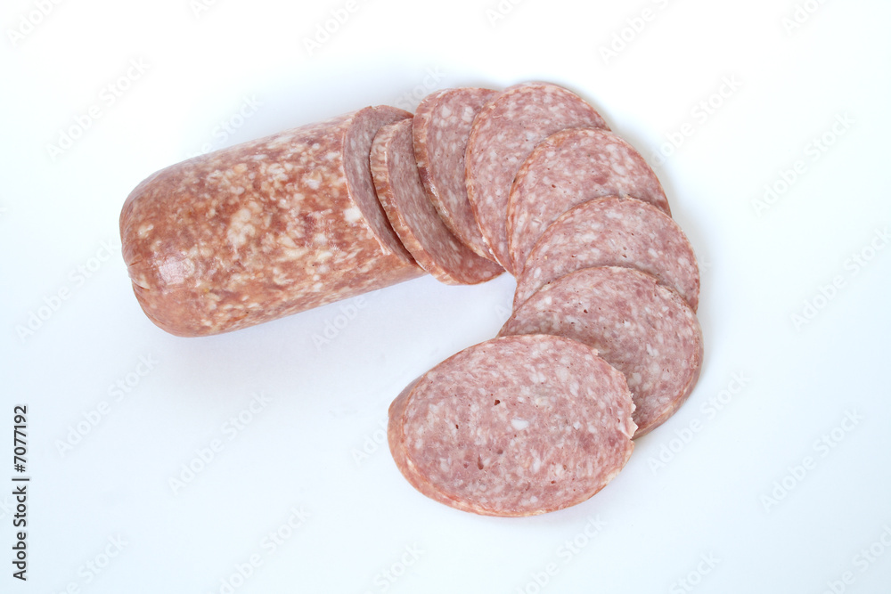 Cutting saveloy and slices of sausage on white background Cutting saveloy and slices of sausage on white background