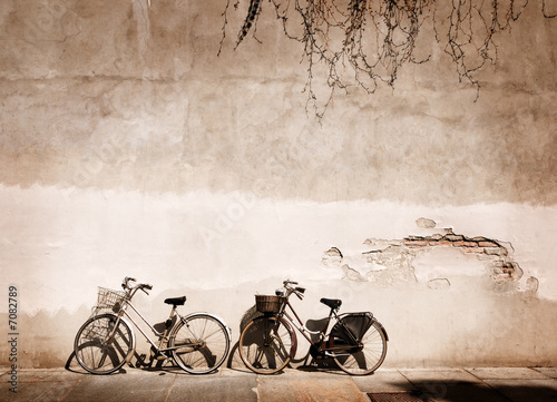 Italian old-style bicycles leaning against a wall  #7082789
