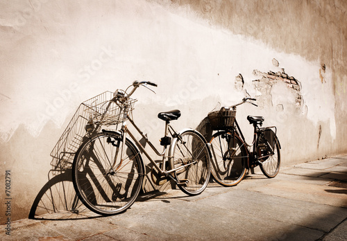 Italian old-style bicycles leaning against a wall  #7082791