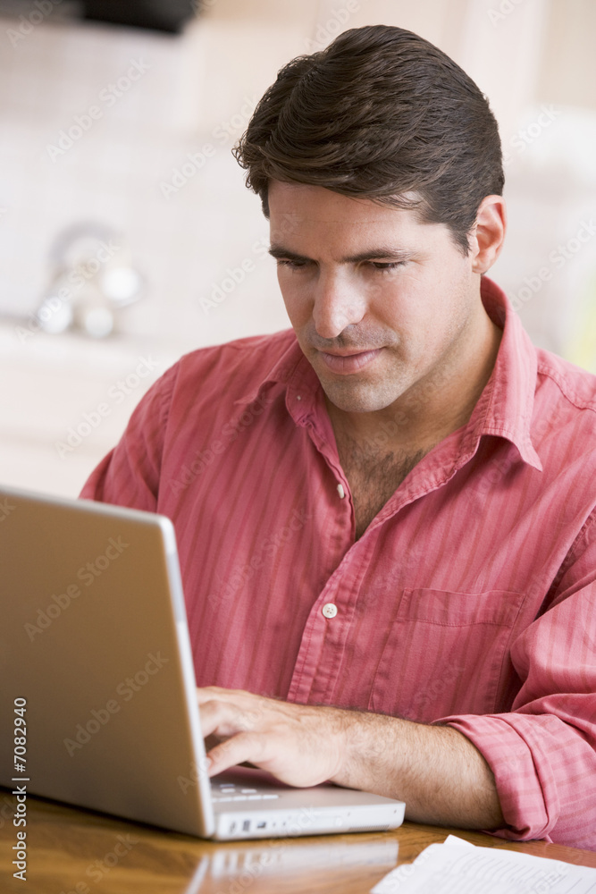 Hispanic man using laptop at home Hispanic man using laptop at home