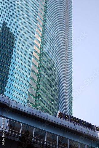commuter train against high rise building