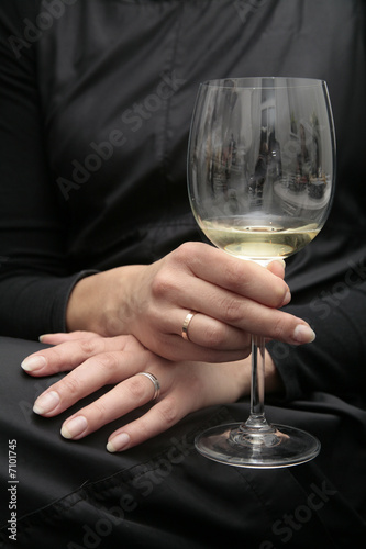 women hand with glass of wine