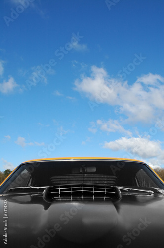 classic american muscle car against blue sky