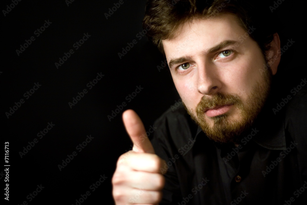 Confident man showing thumbs up sign