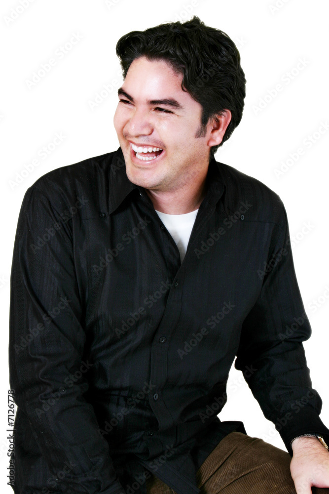 Young Hispanic Man Laughing & Sitting Down Young Hispanic Man Laughing & Sitting Down