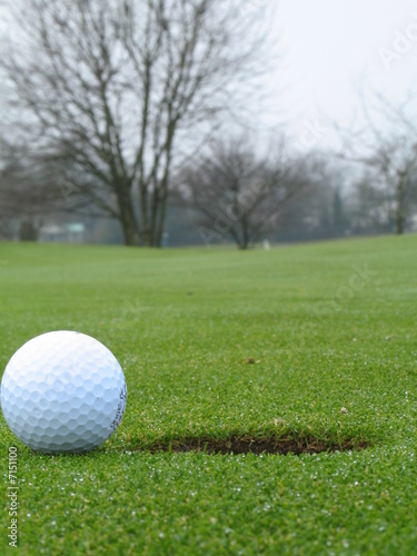 golf ball beside hole
