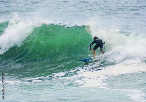 surfer surfs big wave
