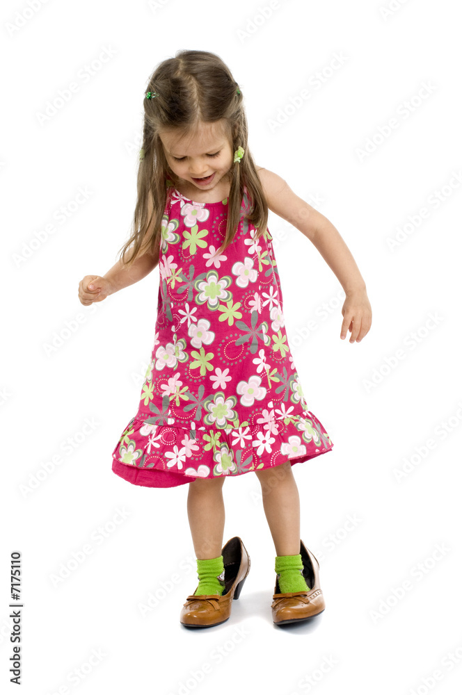 small young girl tries on the mother shoes small young girl tries on the mother shoes