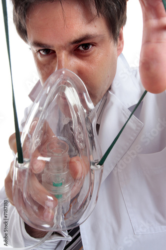 Doctor or anesthetist placing oxygen mask on patient