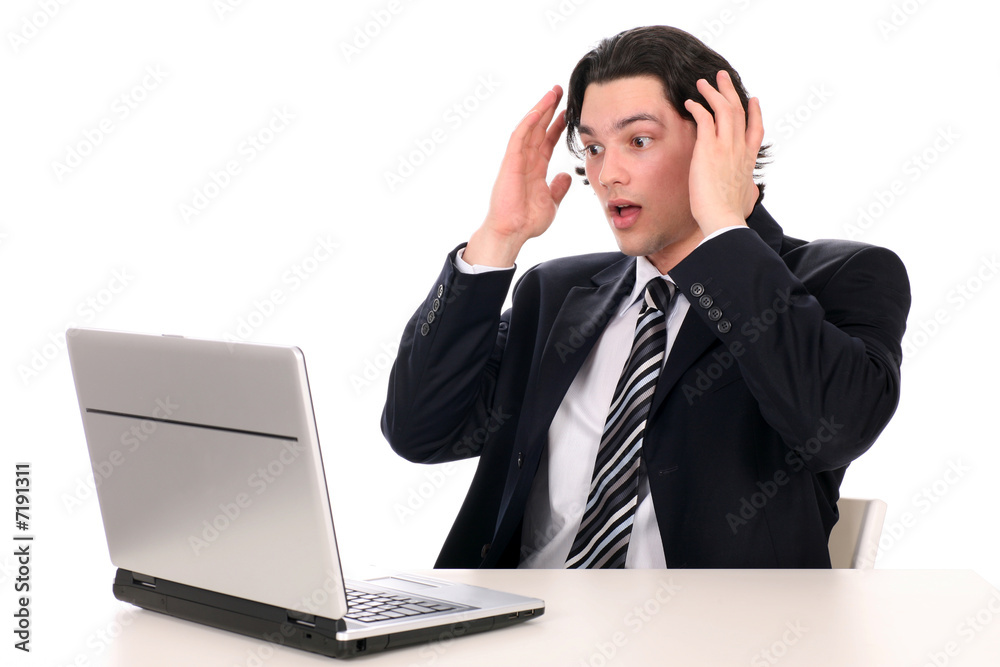 Businessman with laptop, holding head in hands Businessman with laptop, holding head in hands