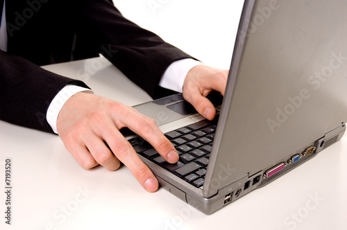 Businessman typing on laptop computer