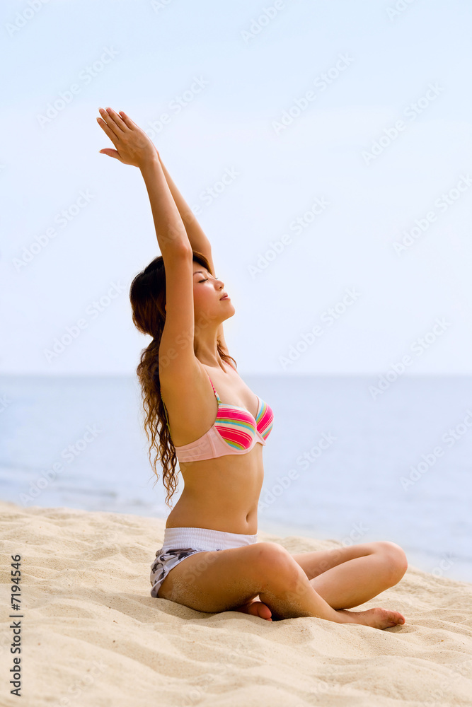 woman doing yoga by stretching her arms