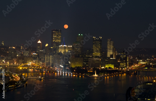 Full Moon over City buildings