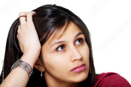 Thoughtful Worried Young Hispanic Woman Holding her Head