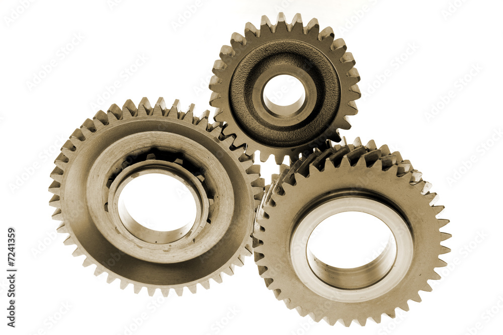 Three gears meshing together over white Three gears meshing together over white