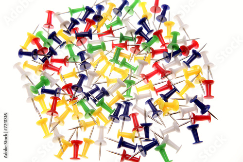 Colorful push-pins over white background