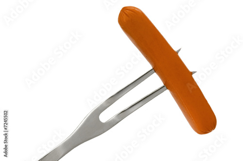 Hot dog on a fork ready for the grill