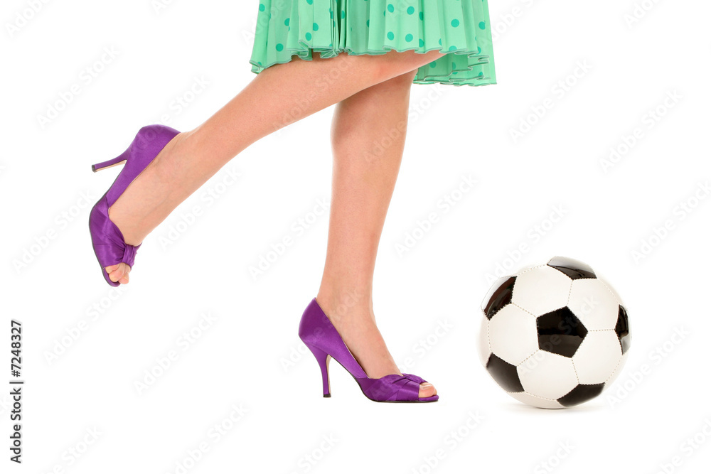 Woman with high heels kicking a soccer ball Stock Photo Adobe Stock