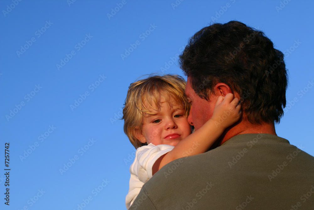 Toddler boy hugging dad