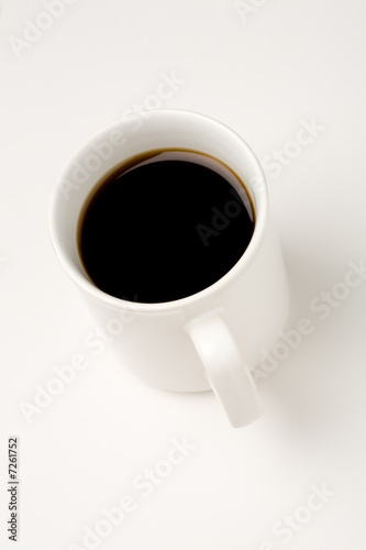 Black coffee in a white mug on white background