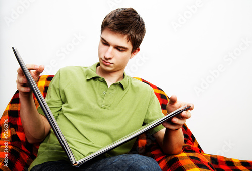 young handsome man with photograph album photo