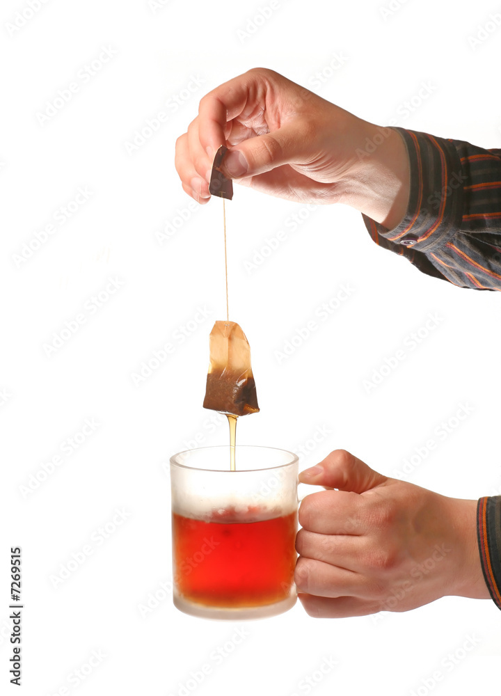 Man’s hands holding tea cup and teabag