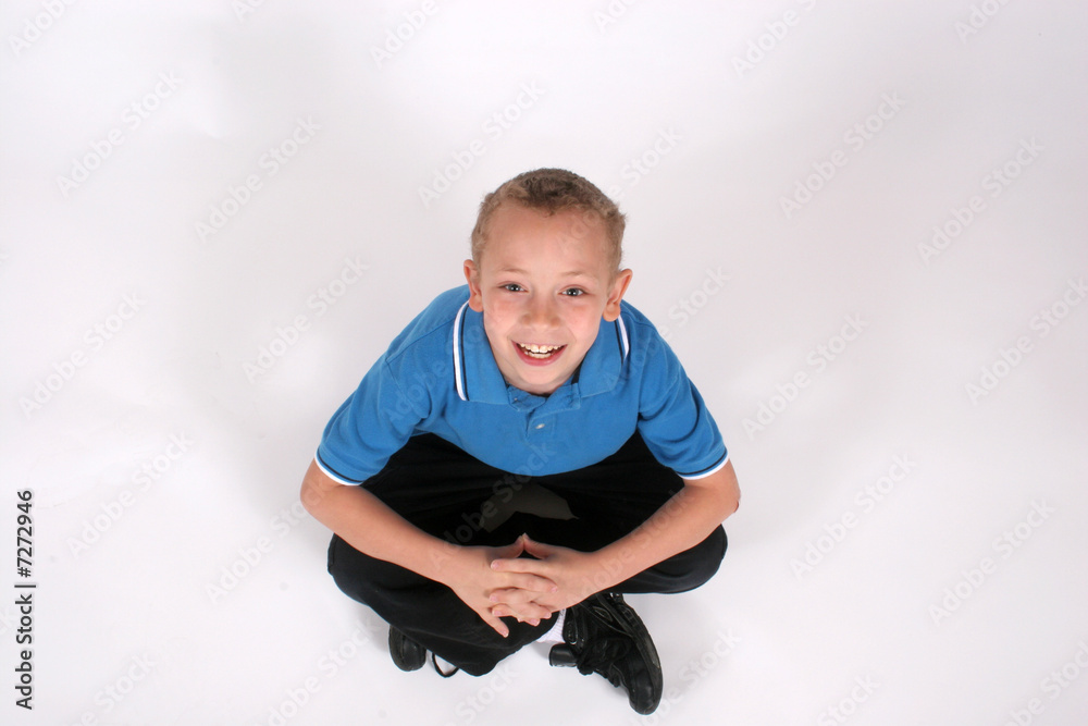 Boy sitting and looking up Boy sitting and looking up