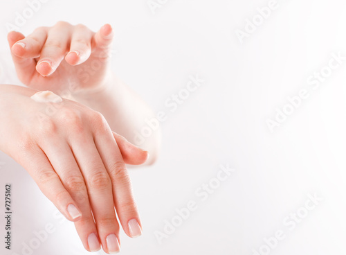 woman applying cream to her hands