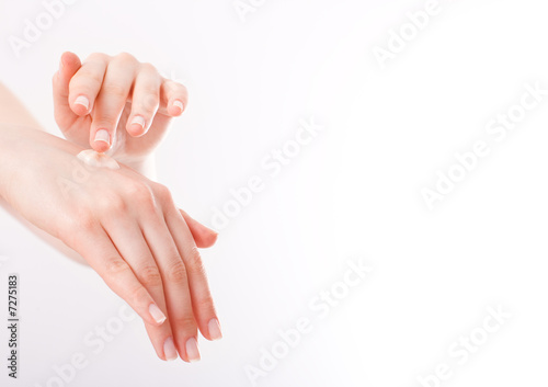 woman applying cream on her hands