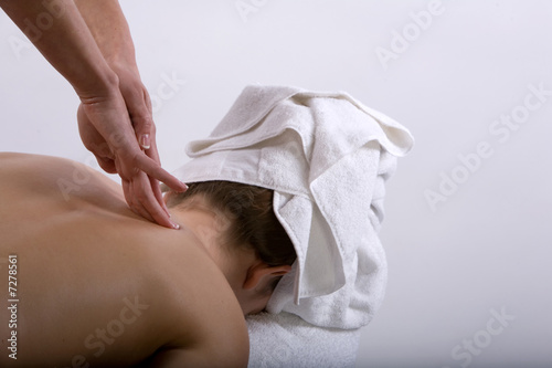 Massage therapist giving a massage photo