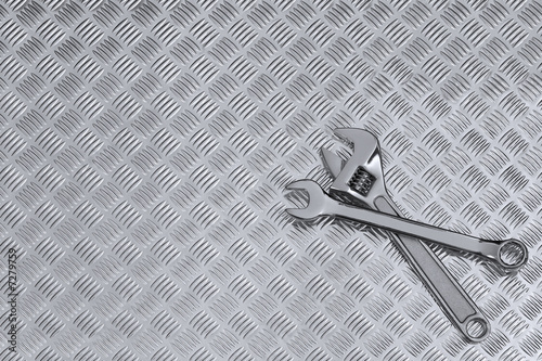 Checkerplate and wrenches background photo