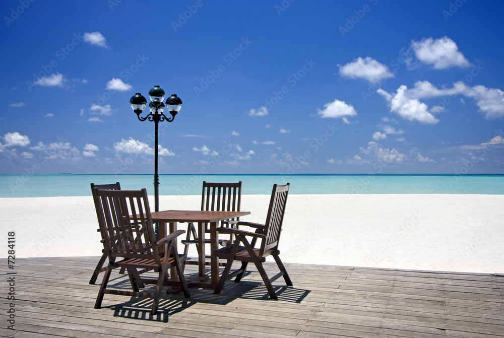 Table and chairs on beach veranda, Maldives
