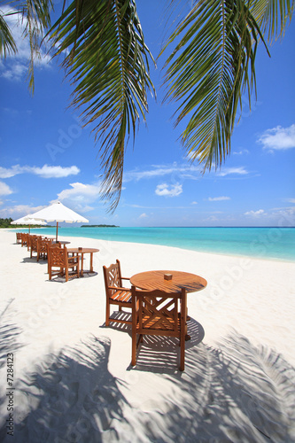 Table and chairs on beach, Maldives