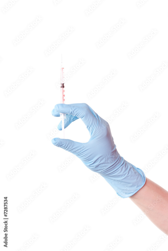 Hand in a glove keeps the syringe Hand in a glove keeps the syringe