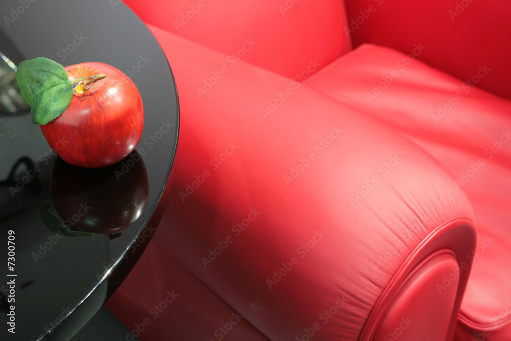Fotografie red apple and a red easy chair