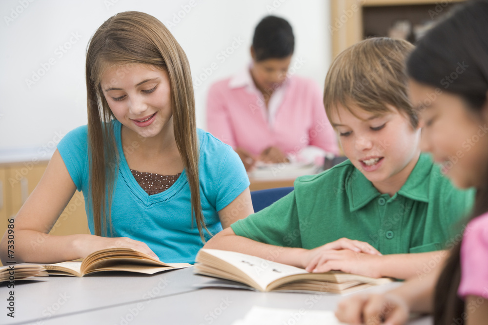 Group of elementary school pupils reading Group of elementary school pupils reading