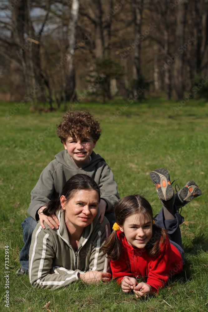 Fototapeta premium Mother with kids resting in park