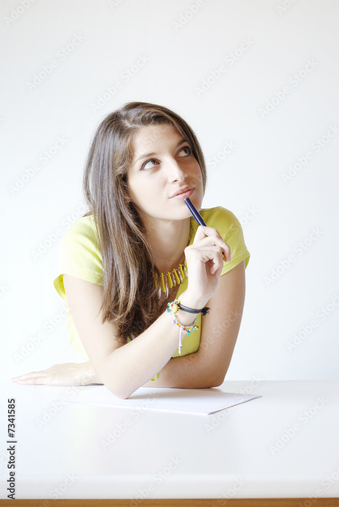 Girl student writes the exercise of the examinations paper