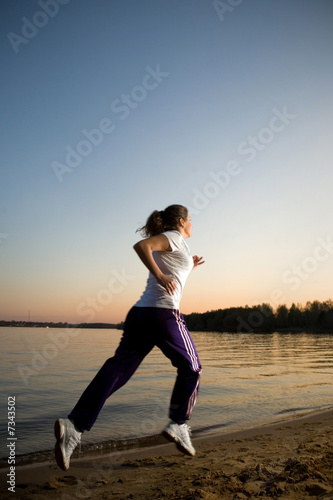 Fototapeta Naklejka Na Ścianę i Meble -  Girl running on a beach