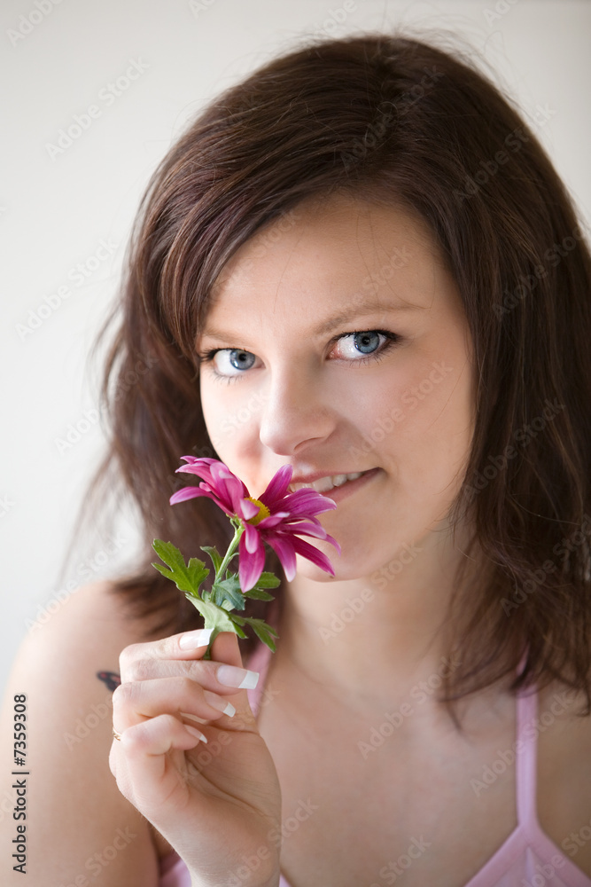Woman holding pink flower Woman holding pink flower